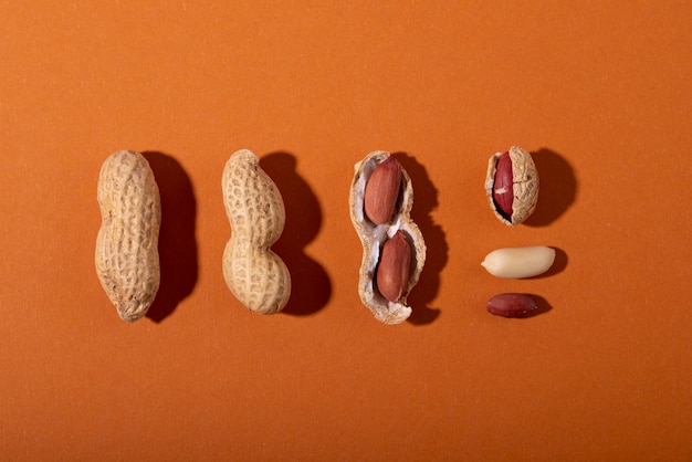 Top view peanuts on orange background