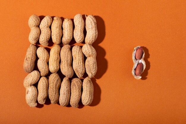 Top view peanuts on orange background