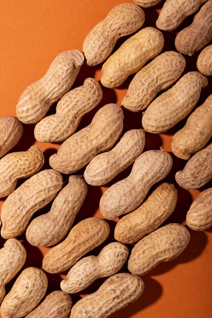 Top view peanuts on orange background