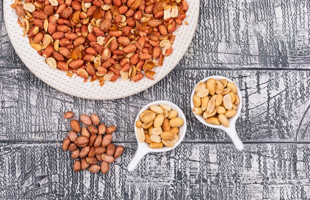 Top view peanuts in plate on wooden  horizontal