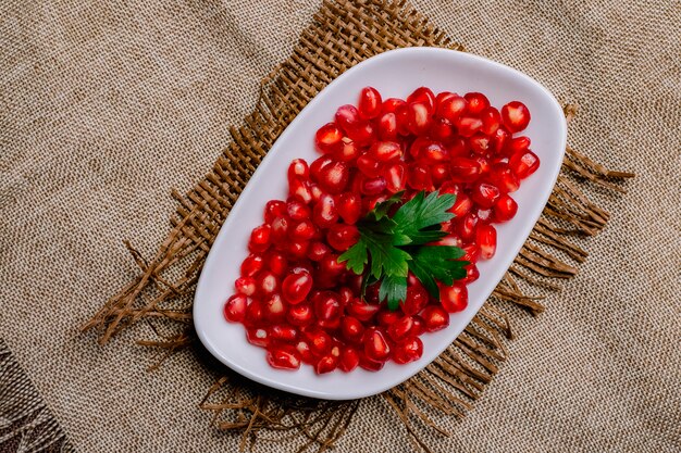 Top view peeled pomegranate with parsley