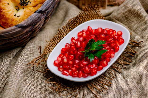 Top view peeled pomegranate with parsley