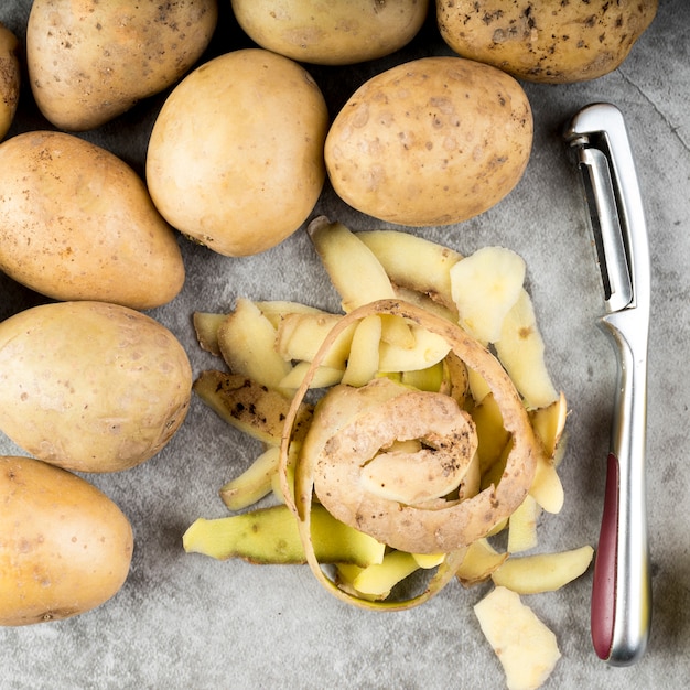 Free photo top view peeling potatoes elements