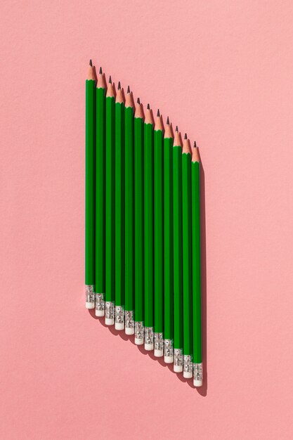 Top view pencils on pink background