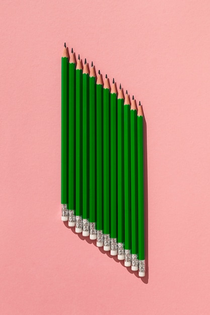 Вид сверху карандаши на розовом фоне