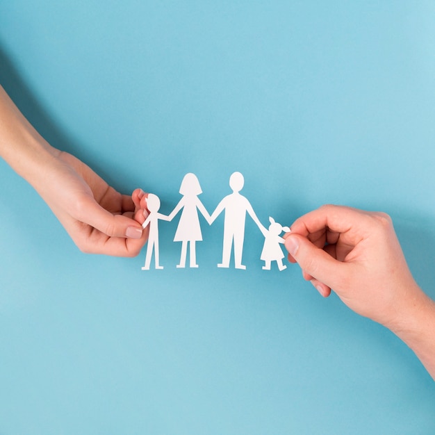top view people holding in hands cute paper family
