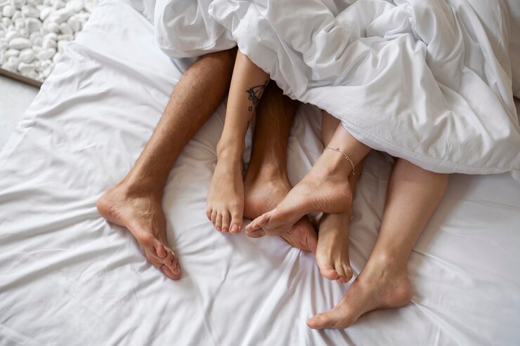 Free Photo top view people laying in bed