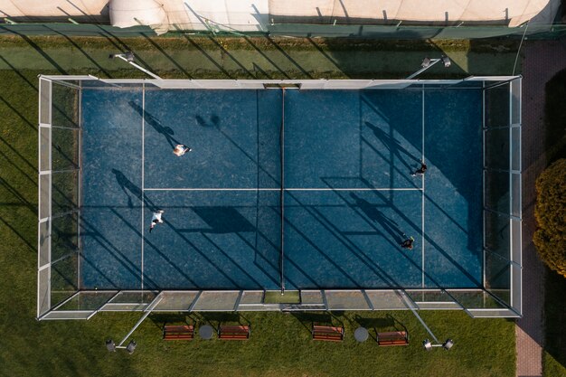 Top view people playing paddle tennis