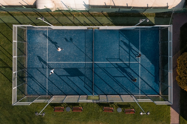 Top view people playing paddle tennis