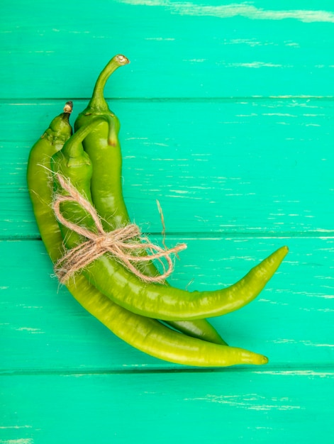 Top view of peppers on green surface