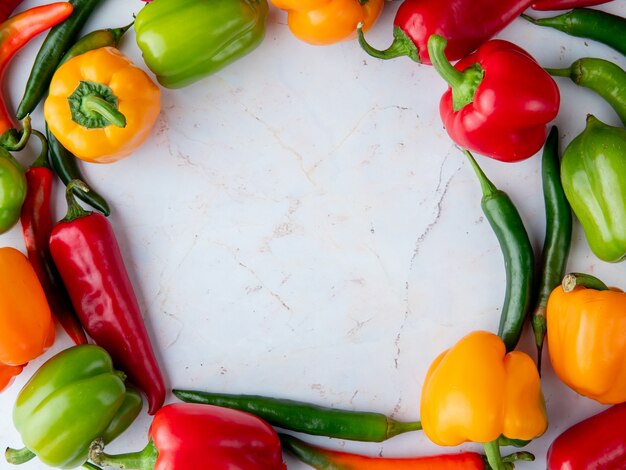 Top view of peppers set in circular shape on white background with copy space