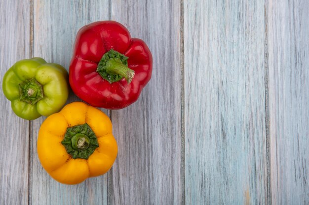Top view of peppers on wooden background with copy space