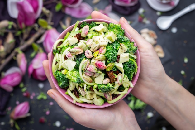 Free photo top view of a person holding a bowl of the delicious vegan salad