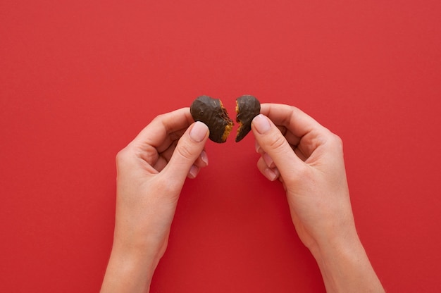 Free photo top view of person holding broken heart treat