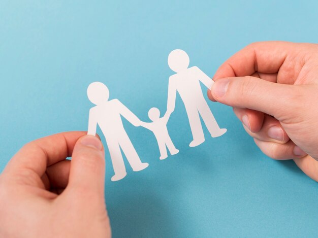top view person holding in hands cute paper family
