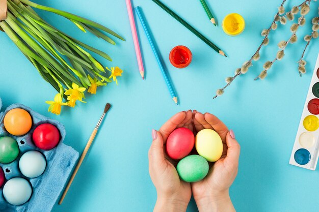 Top view of person painting Easter eggs