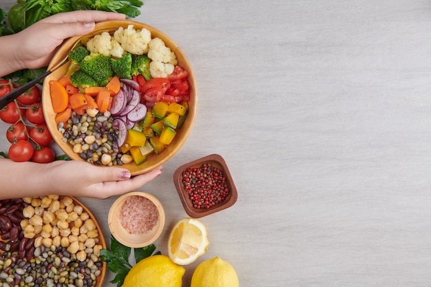 Top view of person raising the salad bowl