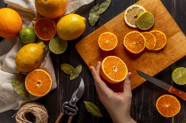 Top view of person slicing citrus fruits