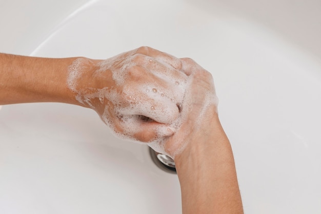 Top view person washing hands