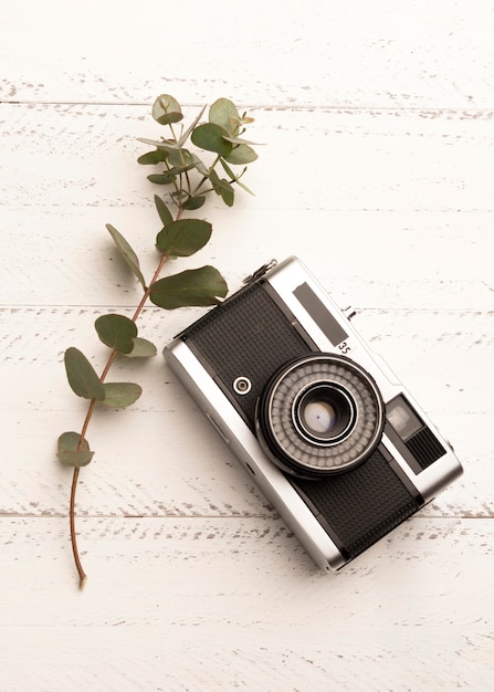 Top view photo camera on wooden table