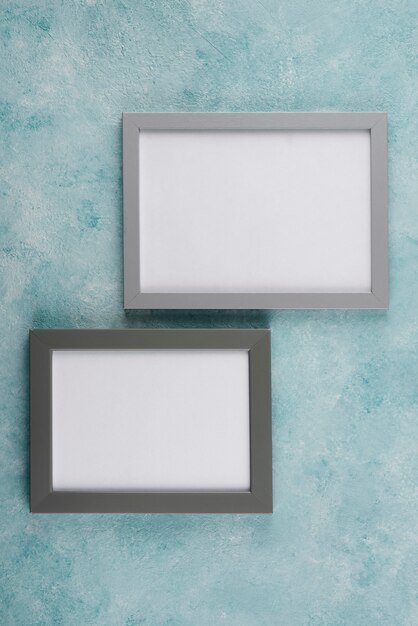 Top view of photo frames on textured surface