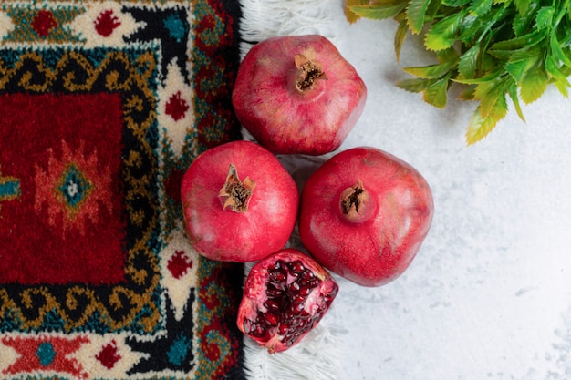 Free photo top view of photo of fresh sliced and whole pomegranate .