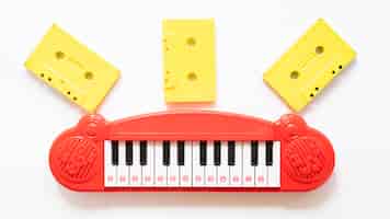 Free photo top view of piano toy and cessettes on plain background