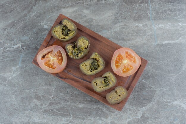 Top view of pickle slices on wooden board.