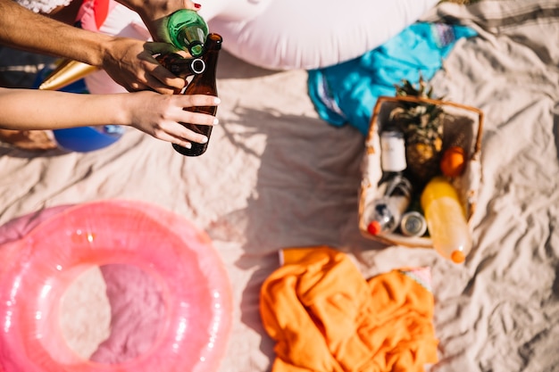 Top view of picnic basket in sand