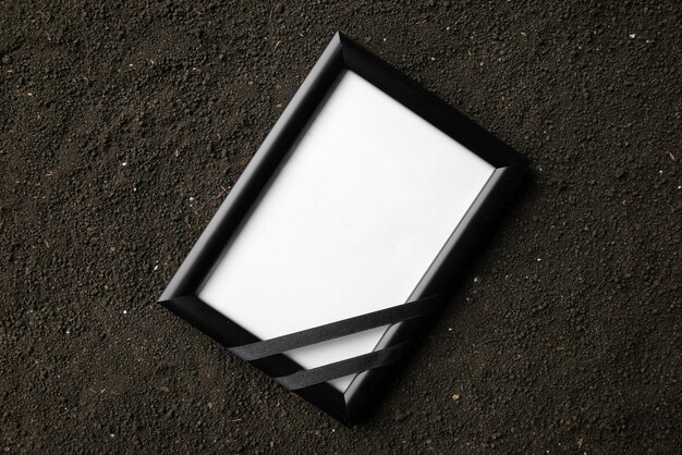 Top view of picture frame on the dark soil