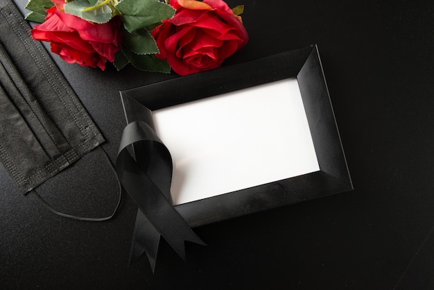 Top view of picture frame with black bow on a dark wall