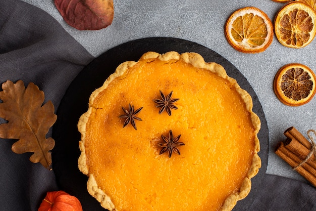 Top view pie and dried slices of lemon