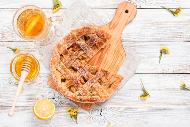 Top view of pie with tea and honey