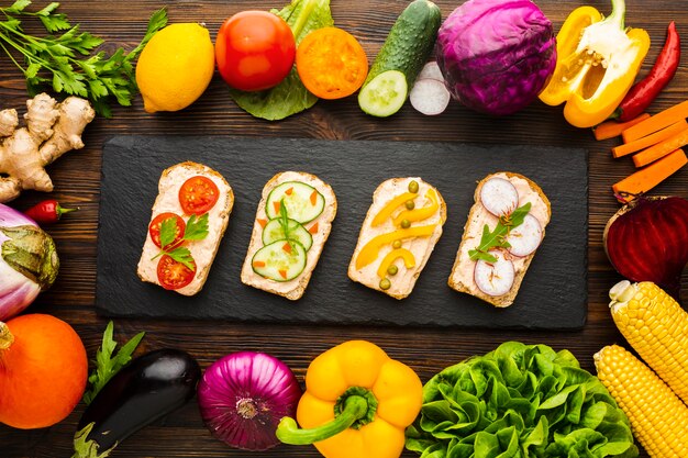 Top view pieces of bread with veggies and vegetable arrangement