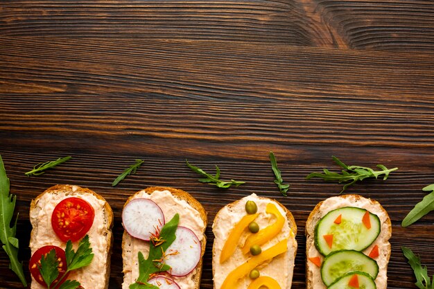 Top view pieces of bread with veggies with copy space