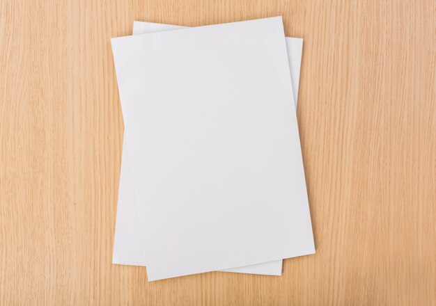 Top view of pieces of paper on wooden table
