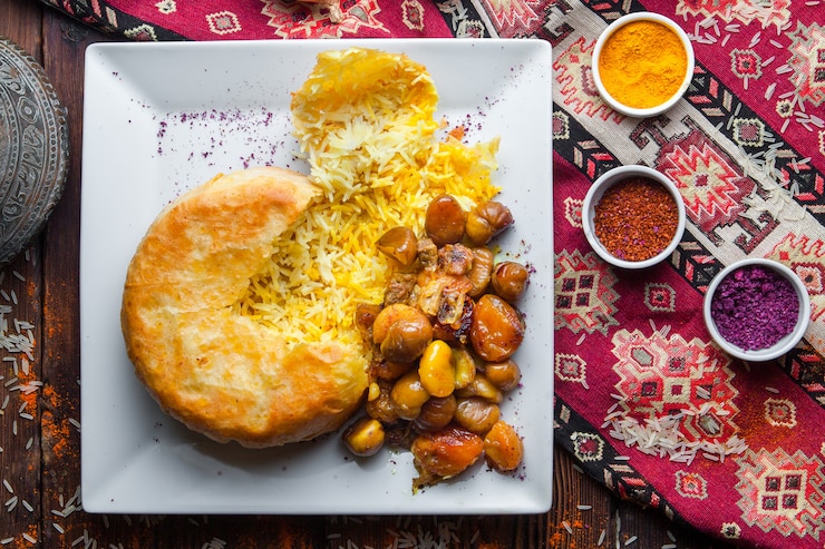 Free Photo top view pilaf in a pita with chestnut, dried apricots, cherry plum. traditional oriental dish on a dark wooden surface horizontal
