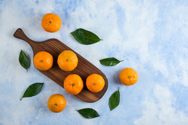 Top view. Pile of clementine mandarins with leaves