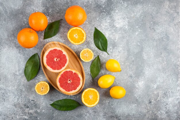 Top view of pile of fresh fruits over grey table.