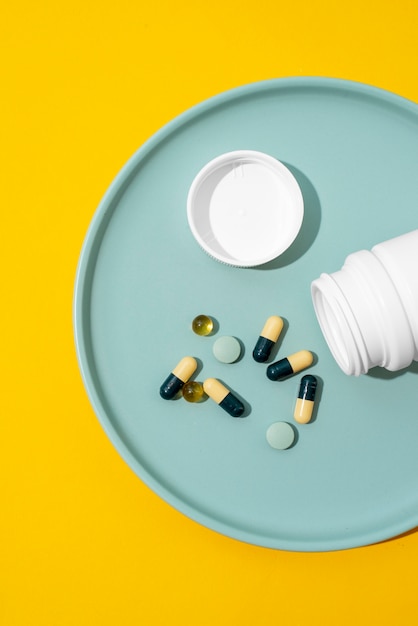 Top view pills container and water glass