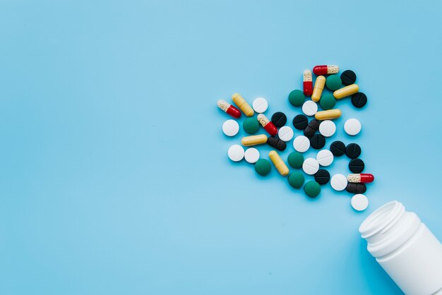 Top view pills going out from jar