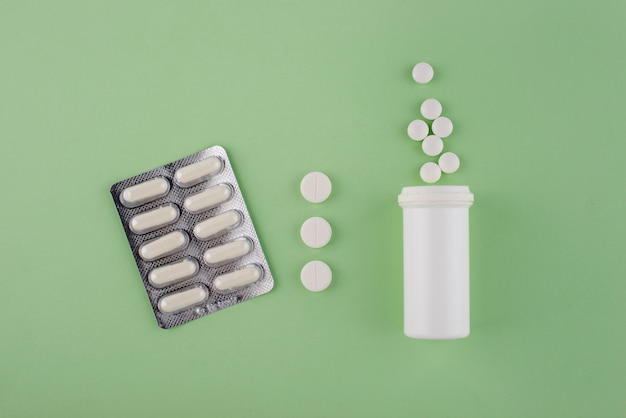 Top view pills on green background