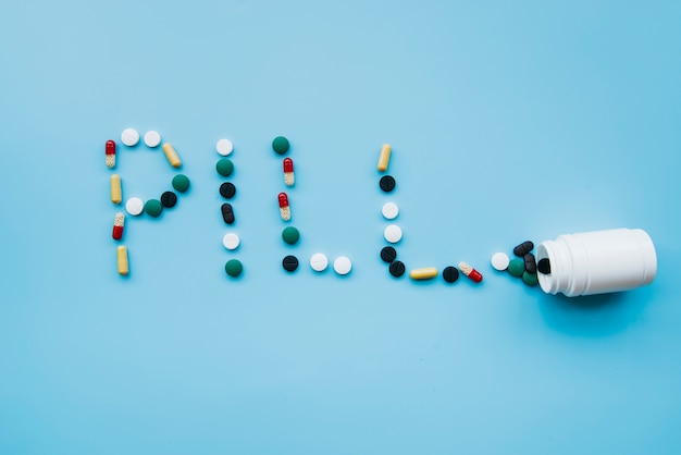 Free photo top view pills making a word
