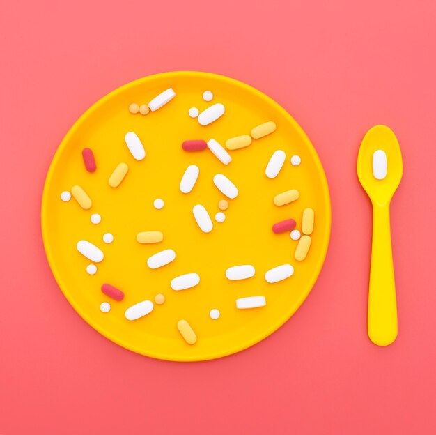 Top view of pills on tray with spoon