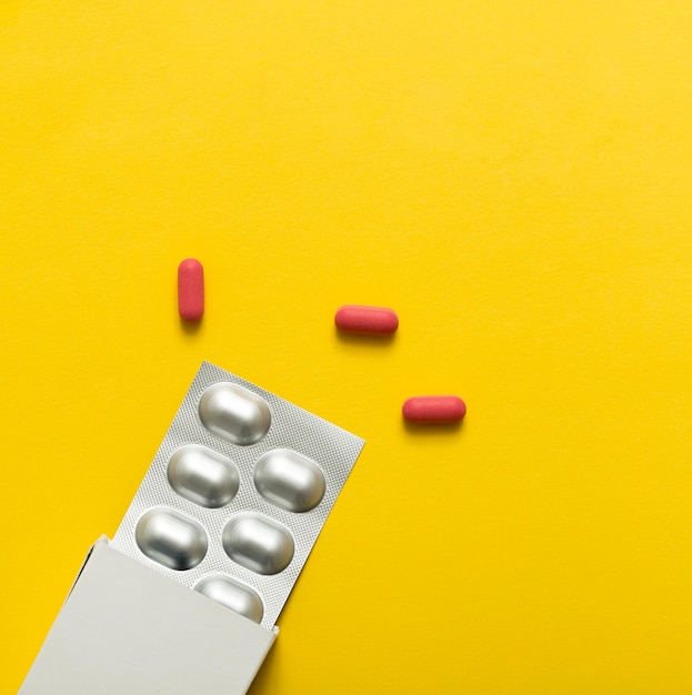 Free photo top view of pills with foil and box