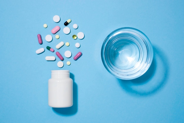 Top view of pills with glass of water