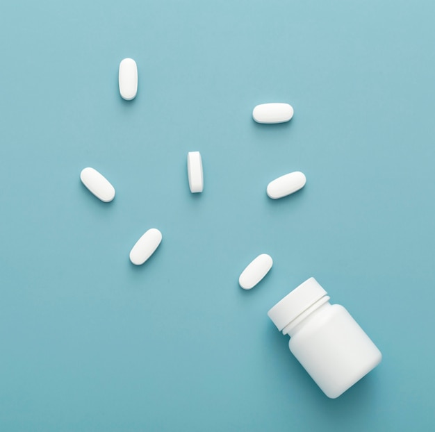 Top view of pills with plastic container