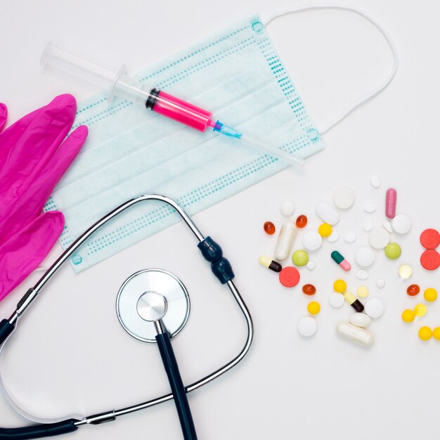 Top view of pills with surgical gloves and stethoscope