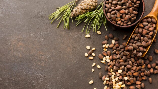 Top view pine seeds with wooden spoon