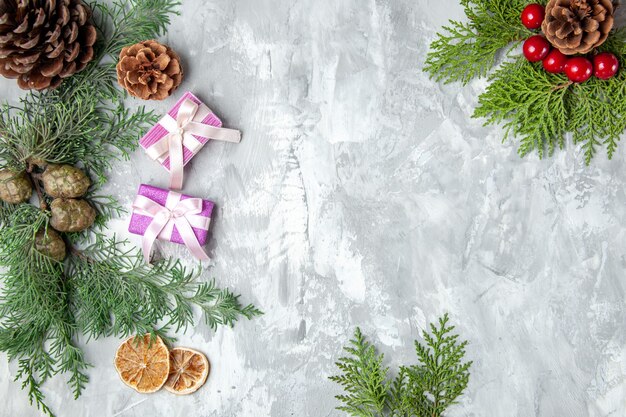 Top view pine tree branches lemon slices pinecones on grey surface